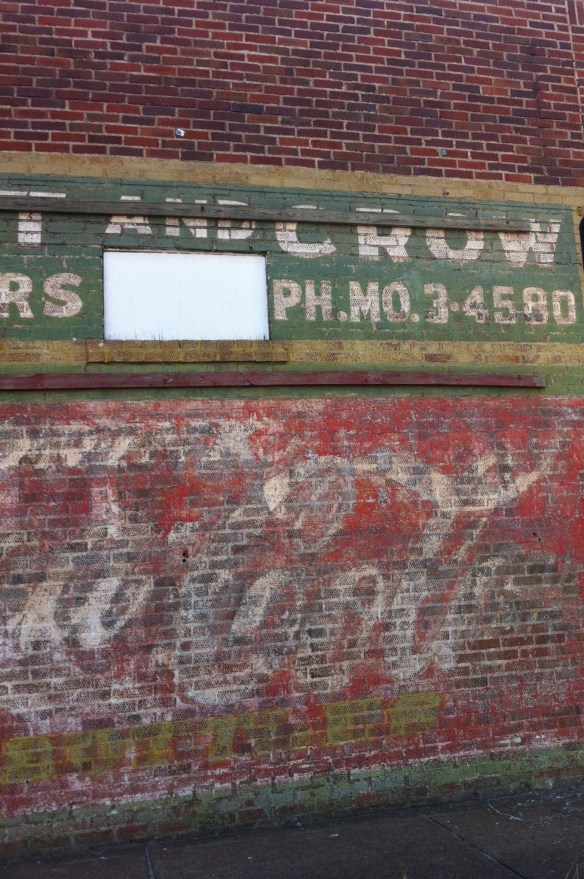 Faded advertisement at 12th and Cedar.